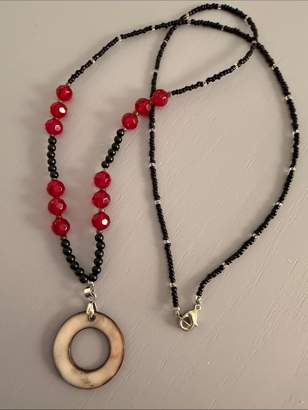 Black and Red Beaded Necklace with Circular Pendant by